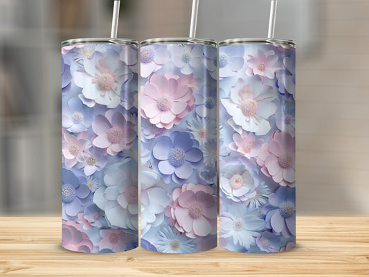 Three tumblers with a pastel floral pattern sit on a wooden surface.
