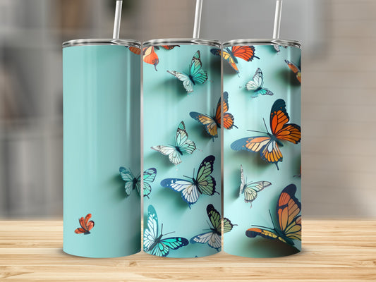 Three tall tumblers with a teal background and colorful butterflies.
