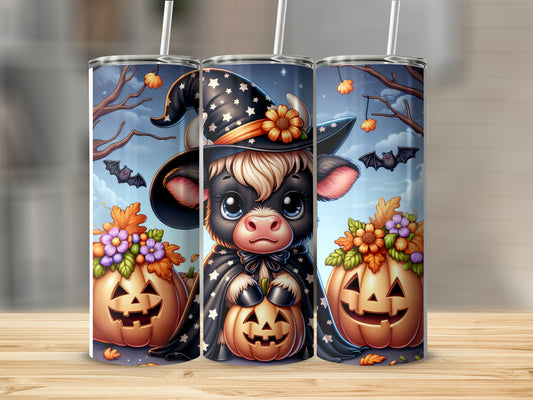 Cute cow in witch hat holding pumpkin on Halloween tumbler.