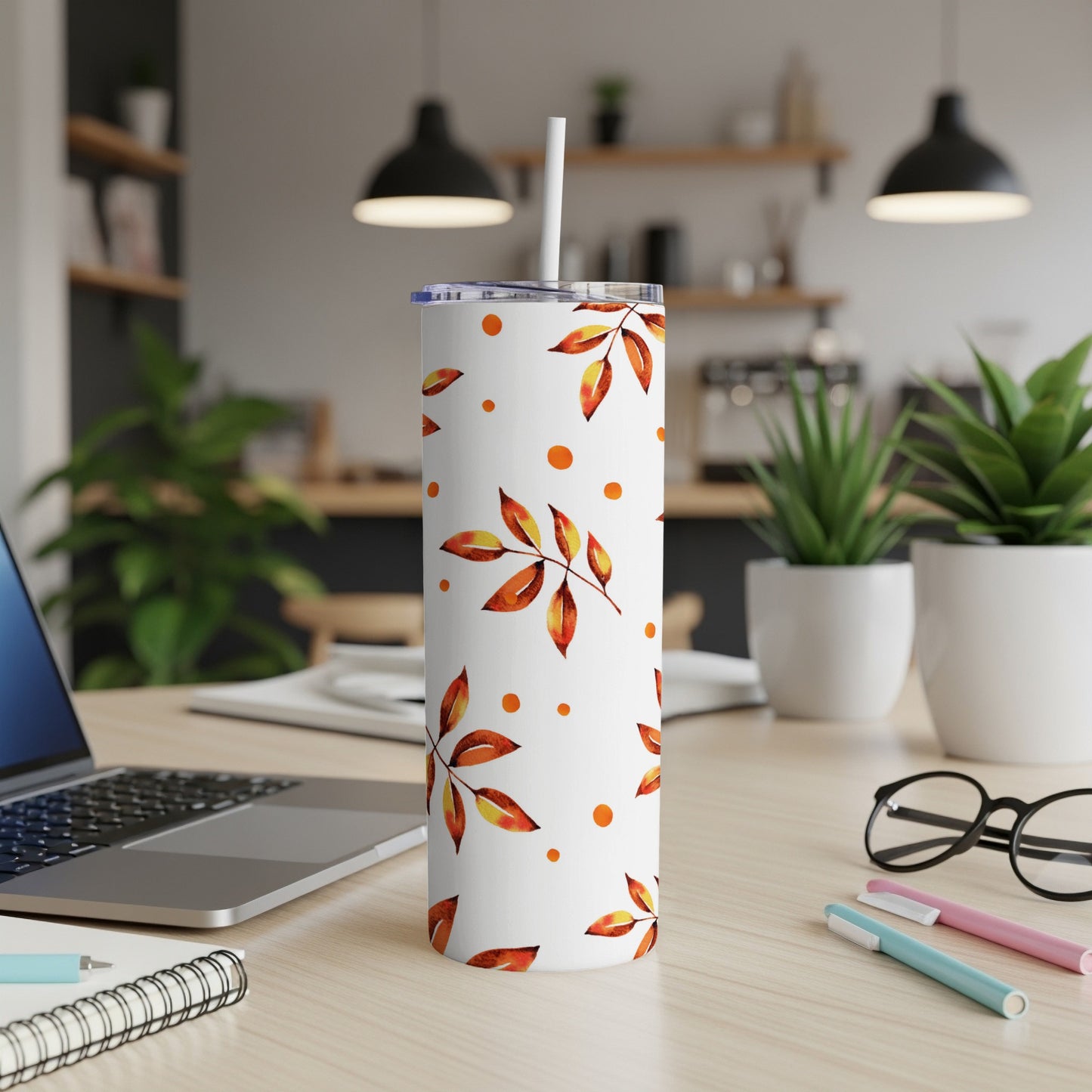 White tumbler with falling autumn leaves and small orange dots pattern.