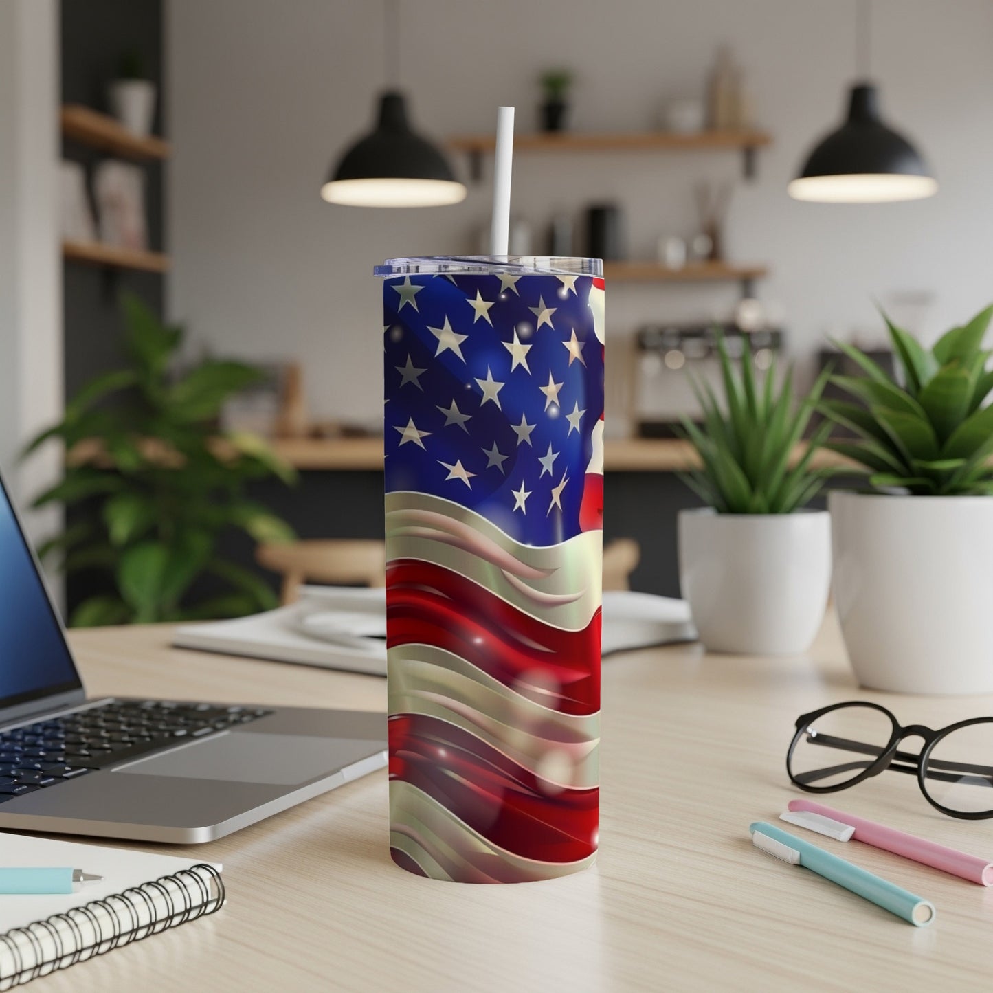 American flag pattern on a silver and red striped tumbler with a white straw.