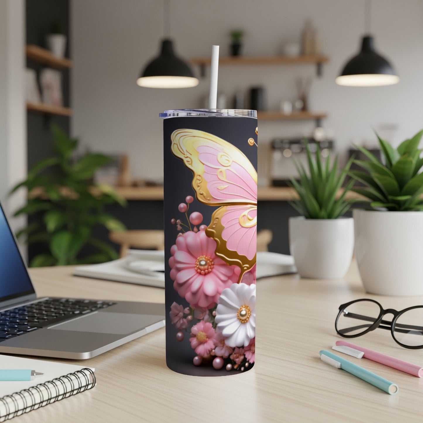 Pink and gold butterfly with flowers on a black tumbler.