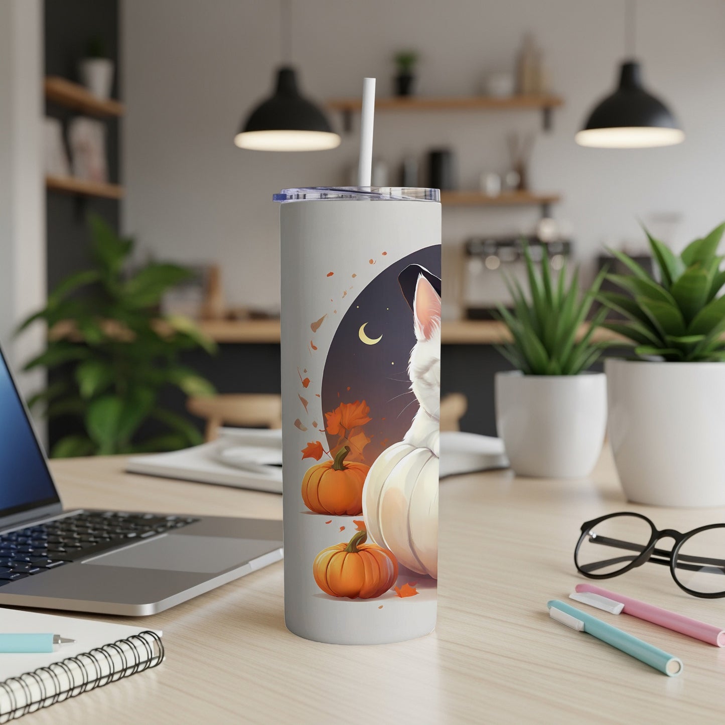 White cat in witch hat with pumpkins and autumn leaves on tumbler.