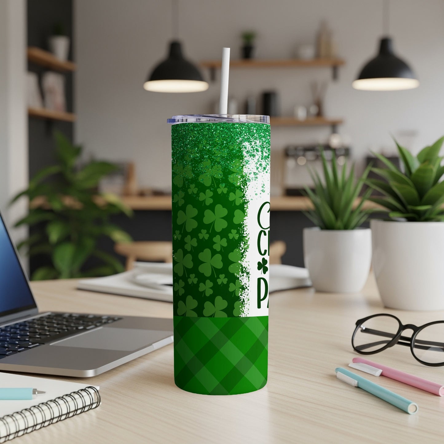 Green tumbler with shamrocks and "Coffee" text on a desk.