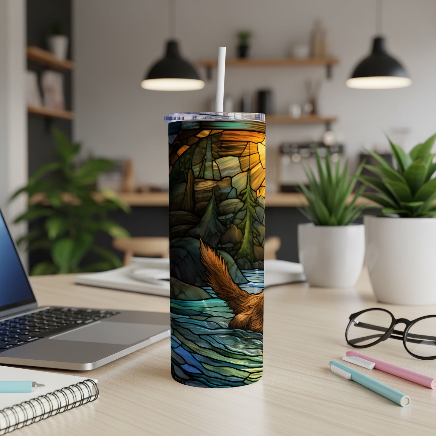 Stained glass tumbler with a forest, river, and mountains design.