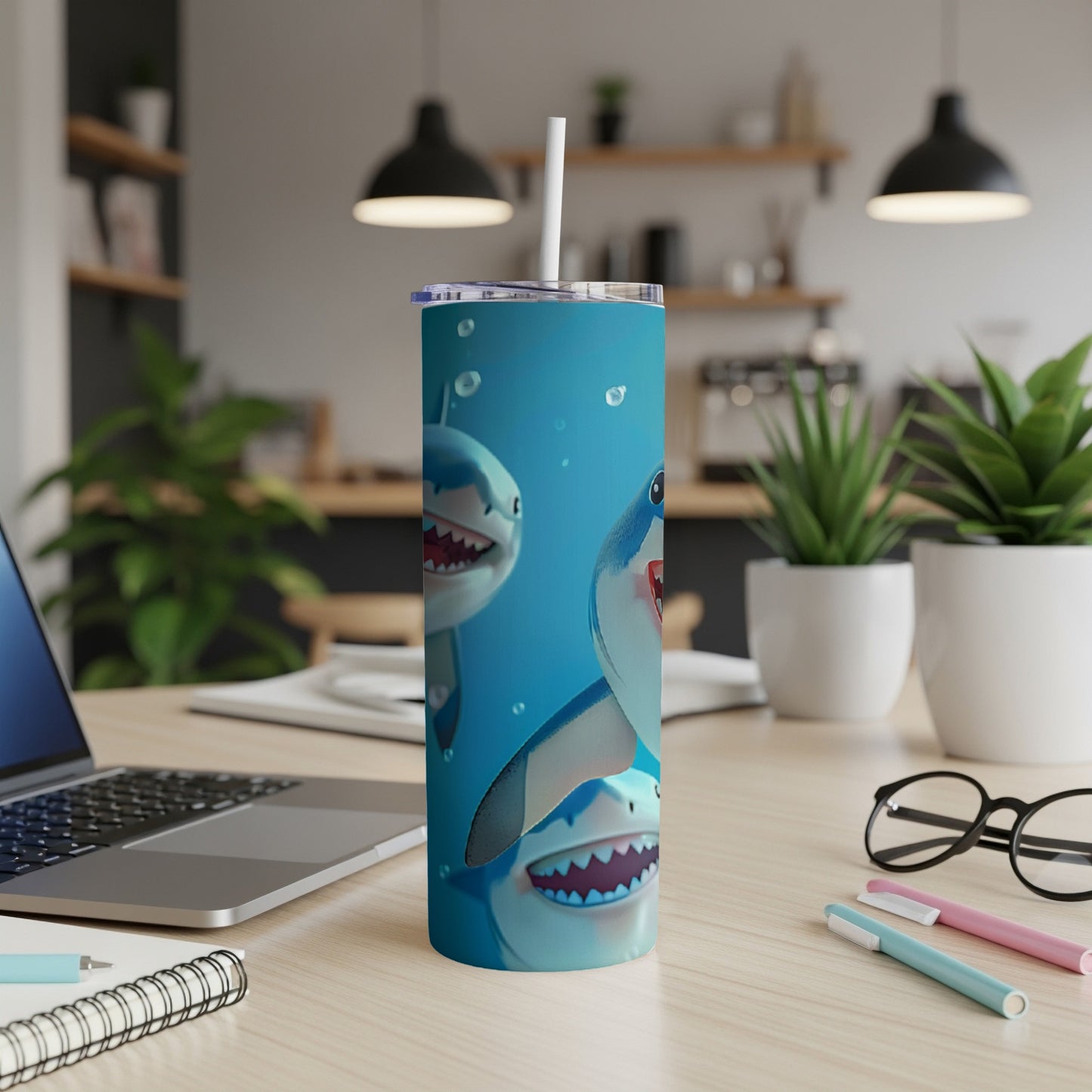Three cartoon sharks with open mouths on a blue background on a skinny tumbler.