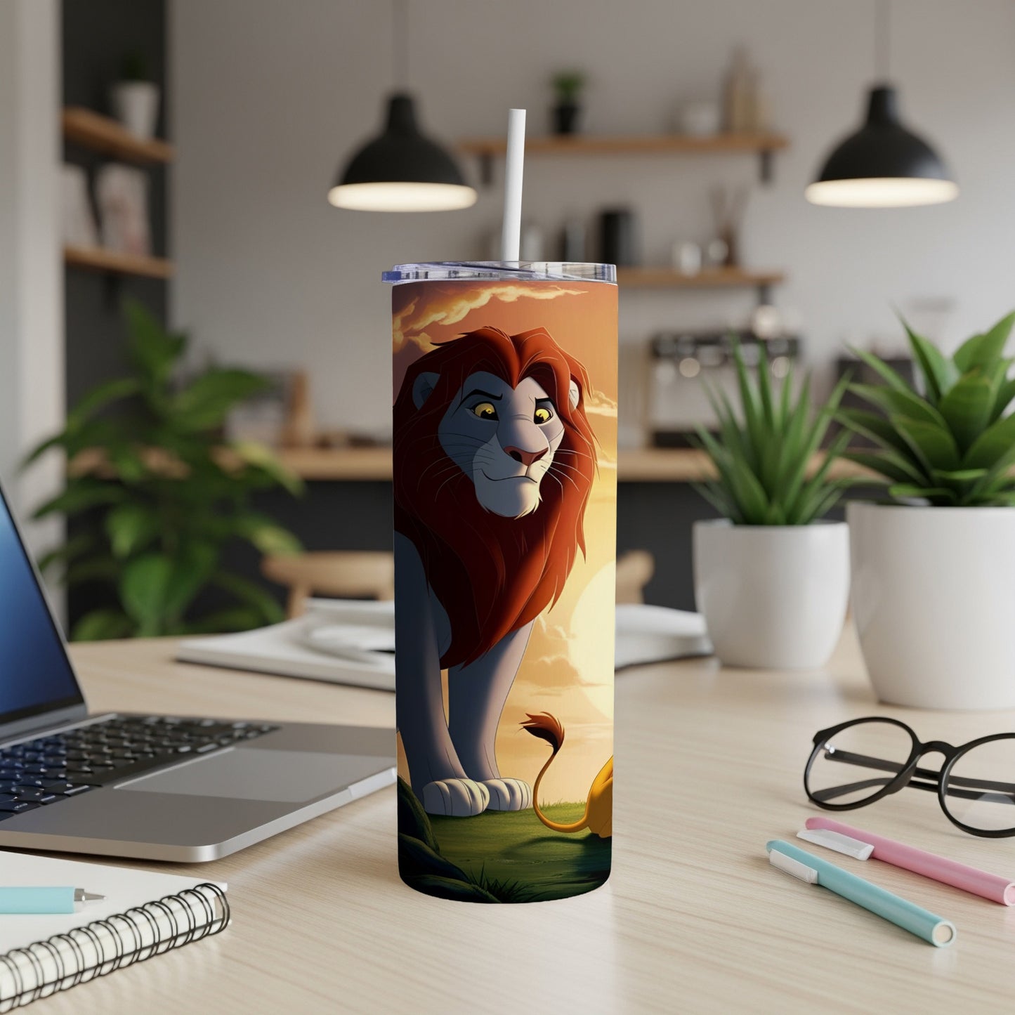 Simba from The Lion King on a tumbler with a straw, on a desk.