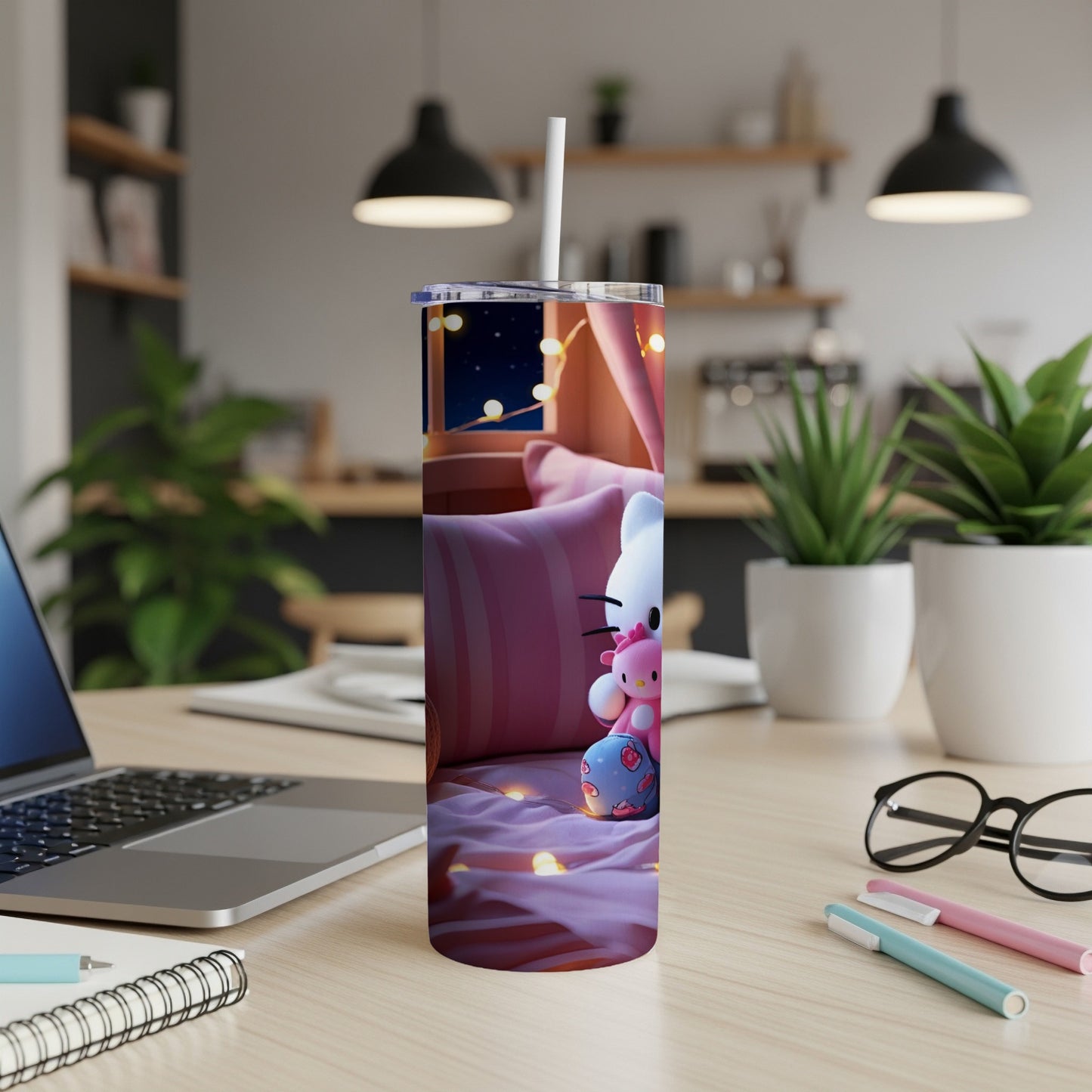 Hello Kitty character on a pink striped tumbler with straw on a desk.