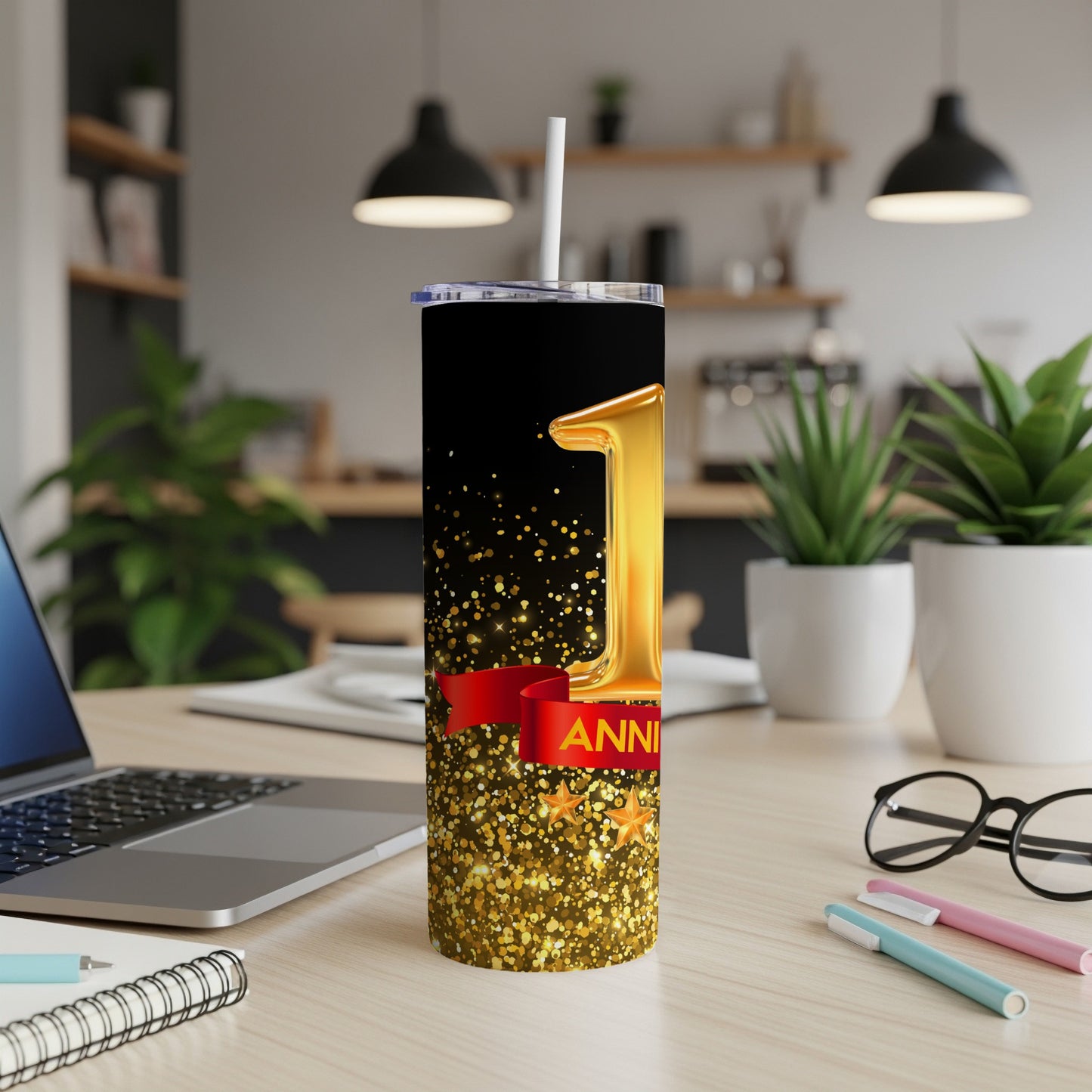 Gold balloon "1" with red ribbon on glittery tumbler, suitable for a first anniversary.