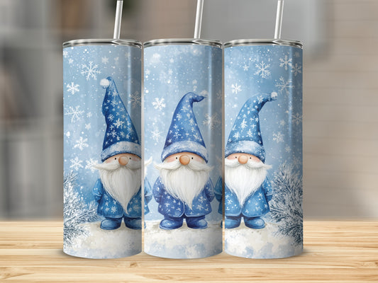 Three blue-hatted gnomes stand in a snowy landscape with snowflakes.