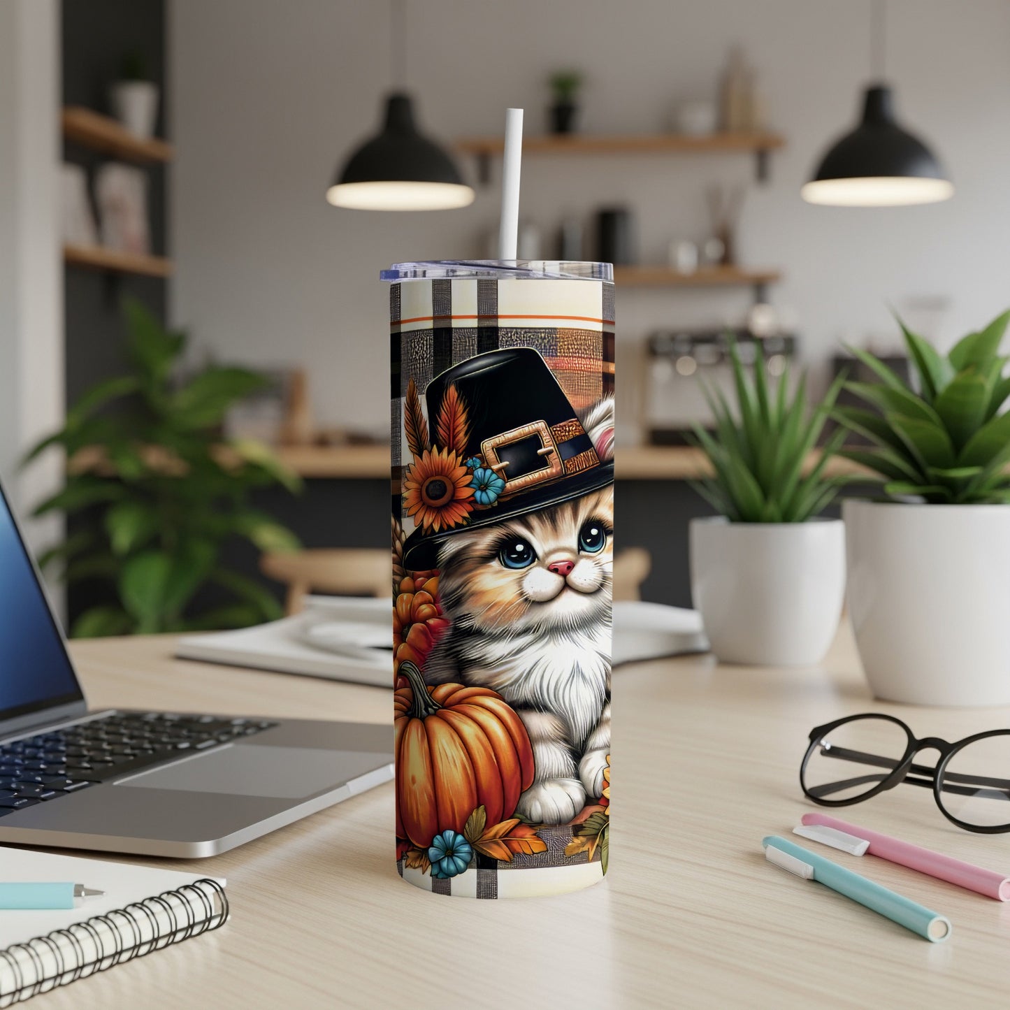 Kitten in a pilgrim hat with pumpkin and sunflowers on a plaid tumbler.