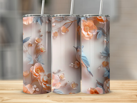 Three tall, skinny tumblers with a floral and bird design on a wooden surface.