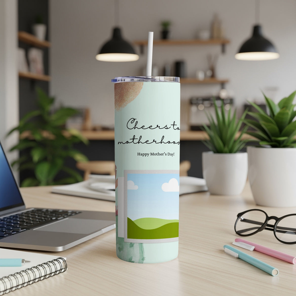 Tumbler with "Cheers to motherhood Happy Mother's Day!" text and landscape photo.