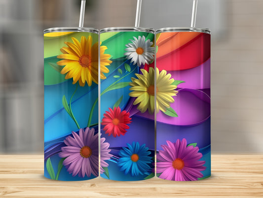 Three tumblers with colorful floral and rainbow wave designs.