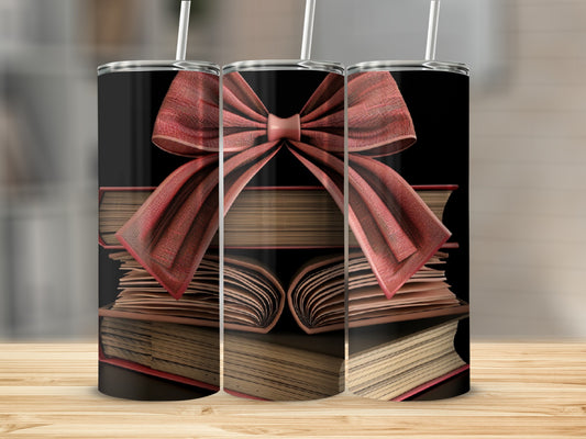 Three tumblers with stacked books and red ribbon bows.
