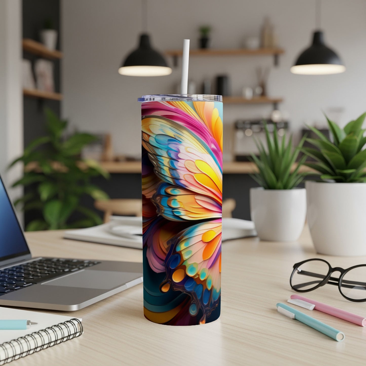 Colorful butterfly wings pattern on a white skinny tumbler with straw.