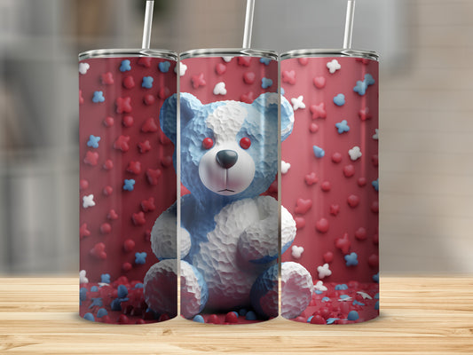 Blue and white teddy bear tumbler with red accents, surrounded by confetti.