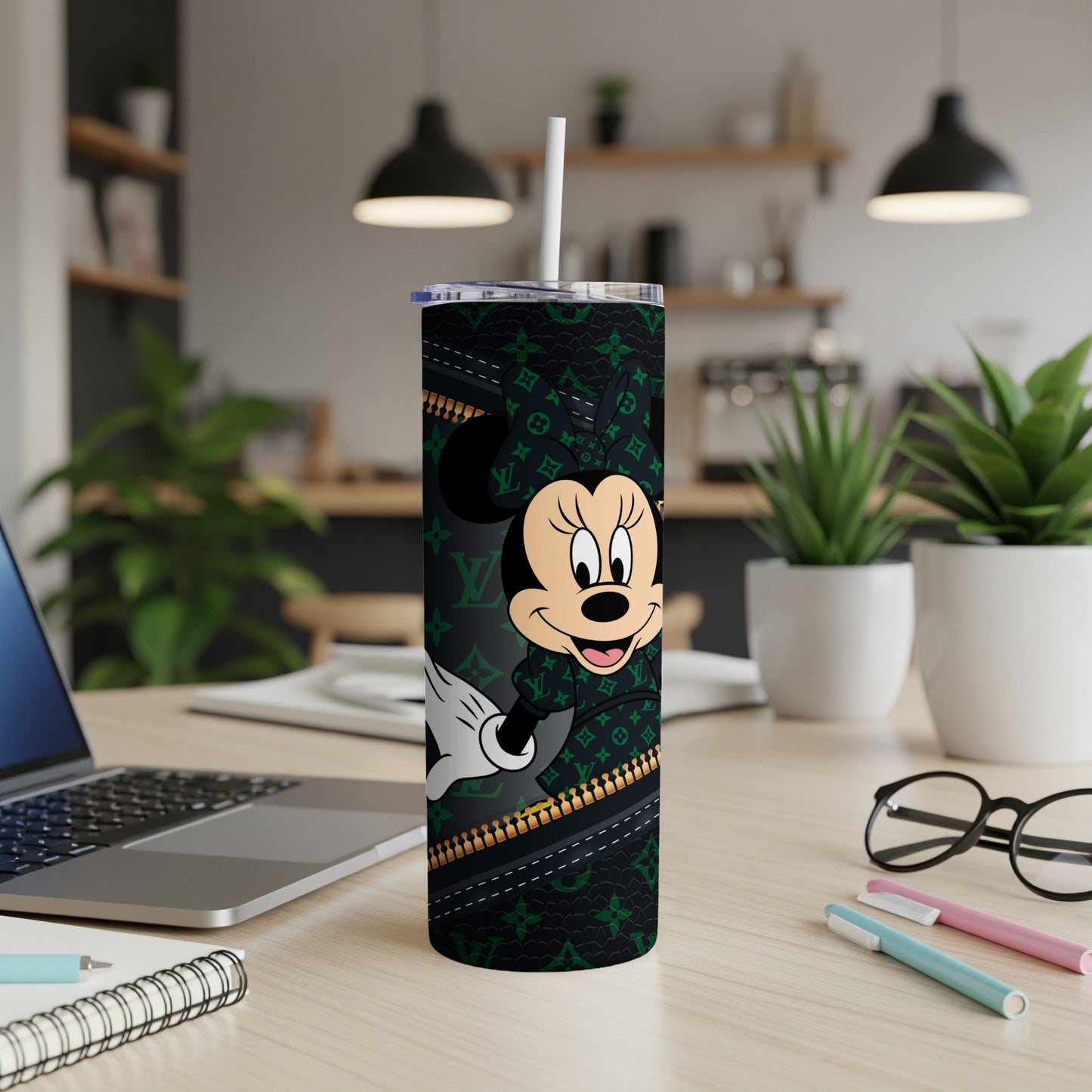 Minnie Mouse on a black tumbler with green and gold designer print.