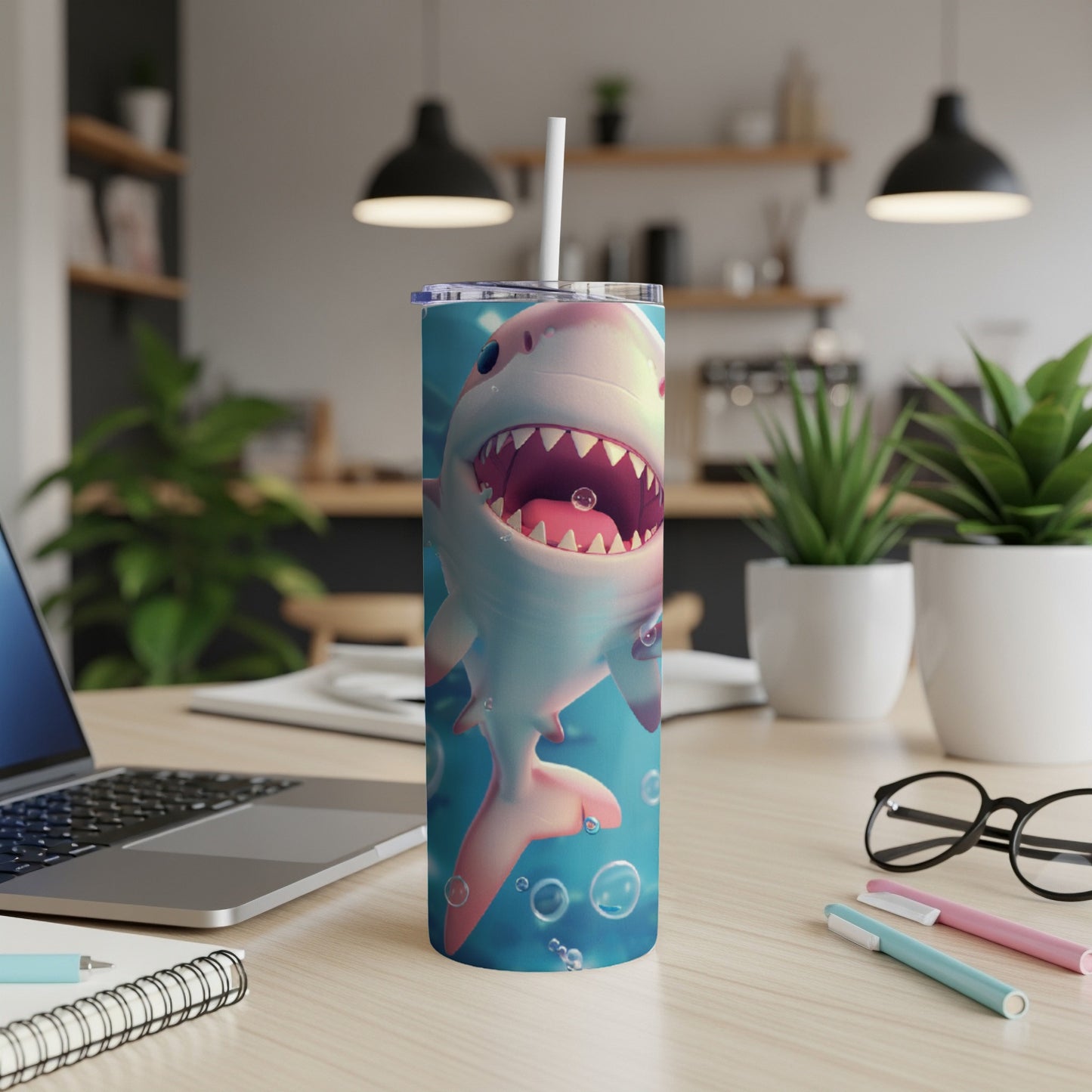 Pink cartoon shark with open mouth and bubbles on a tumbler with straw.