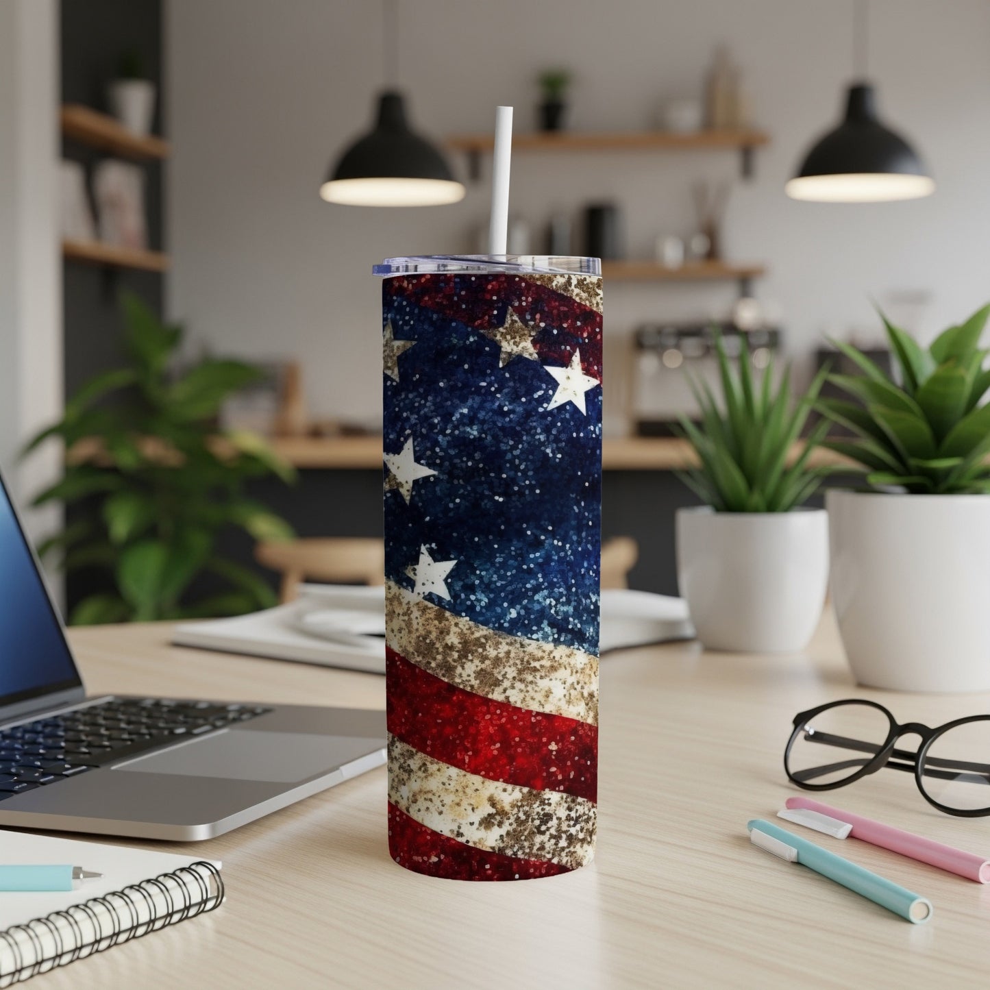American flag tumbler with white straw on a desk.