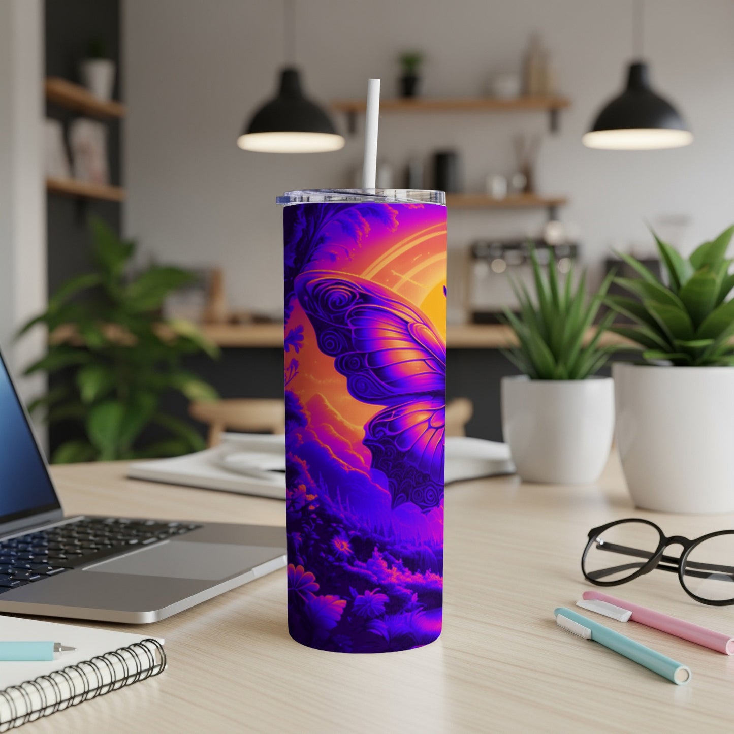 Purple and orange butterfly design on a tumbler with a straw.