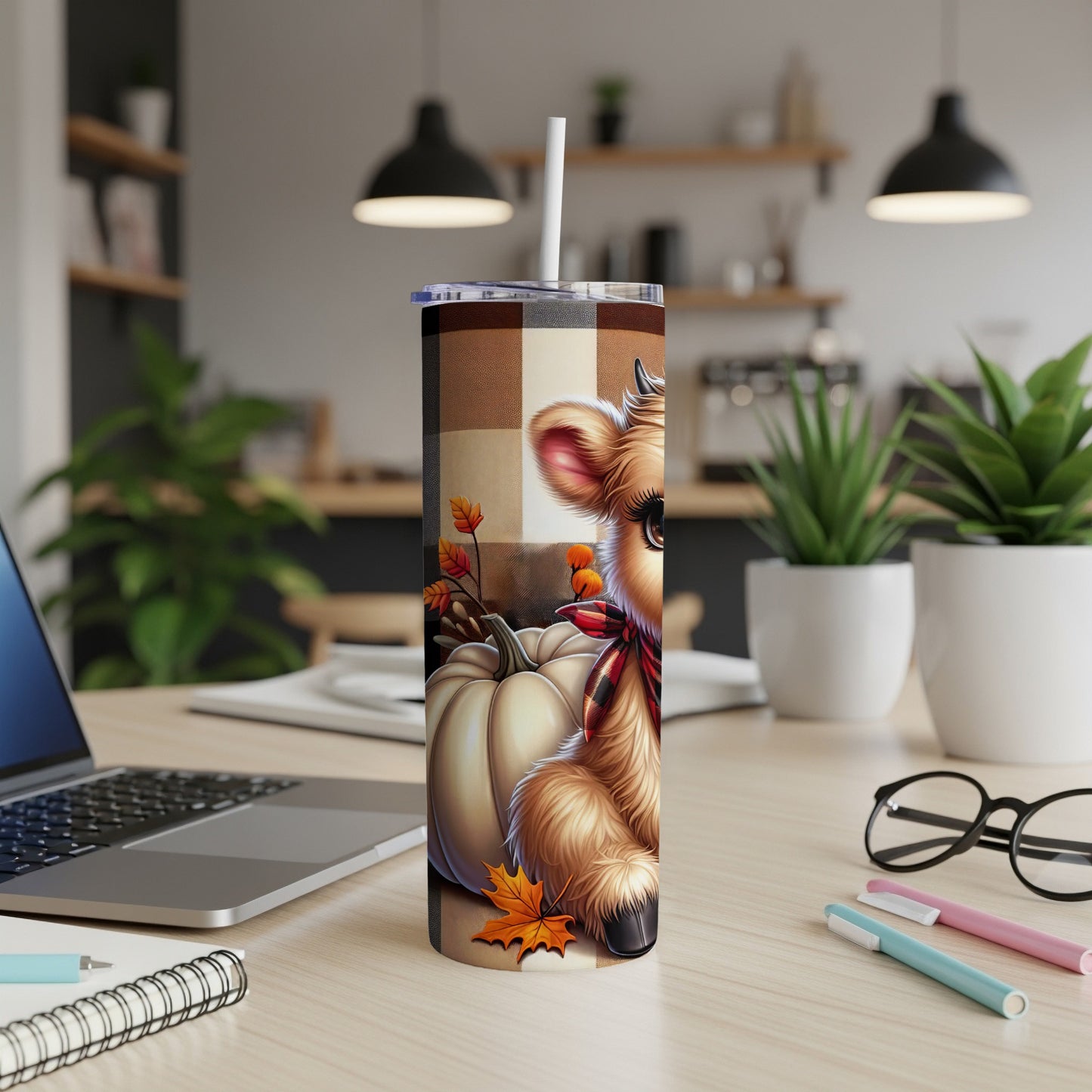 Cow with pumpkin and fall leaves on a checkered tumbler.