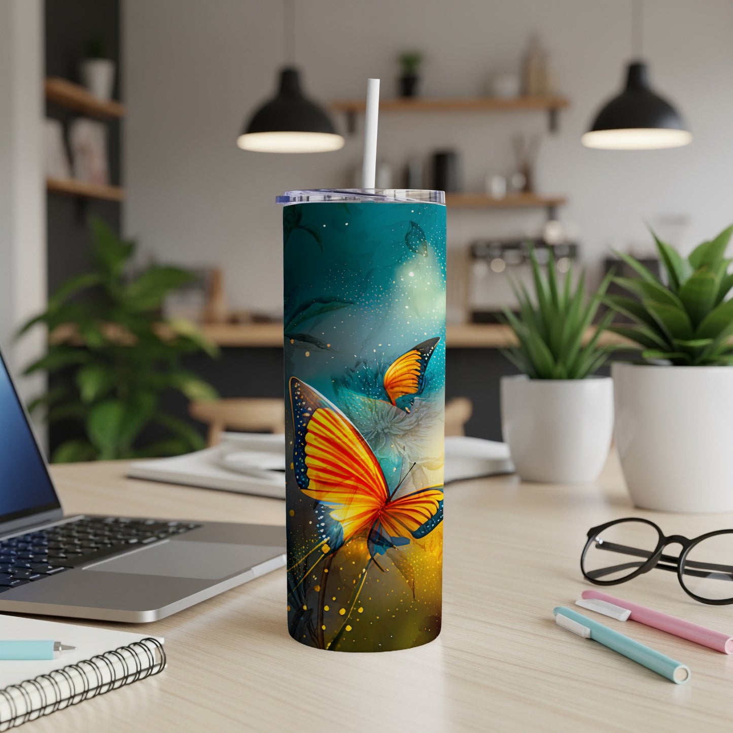 Colorful butterfly design on a white skinny tumbler with a straw.