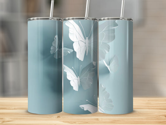 Three blue tumblers with raised white butterfly designs and straws.