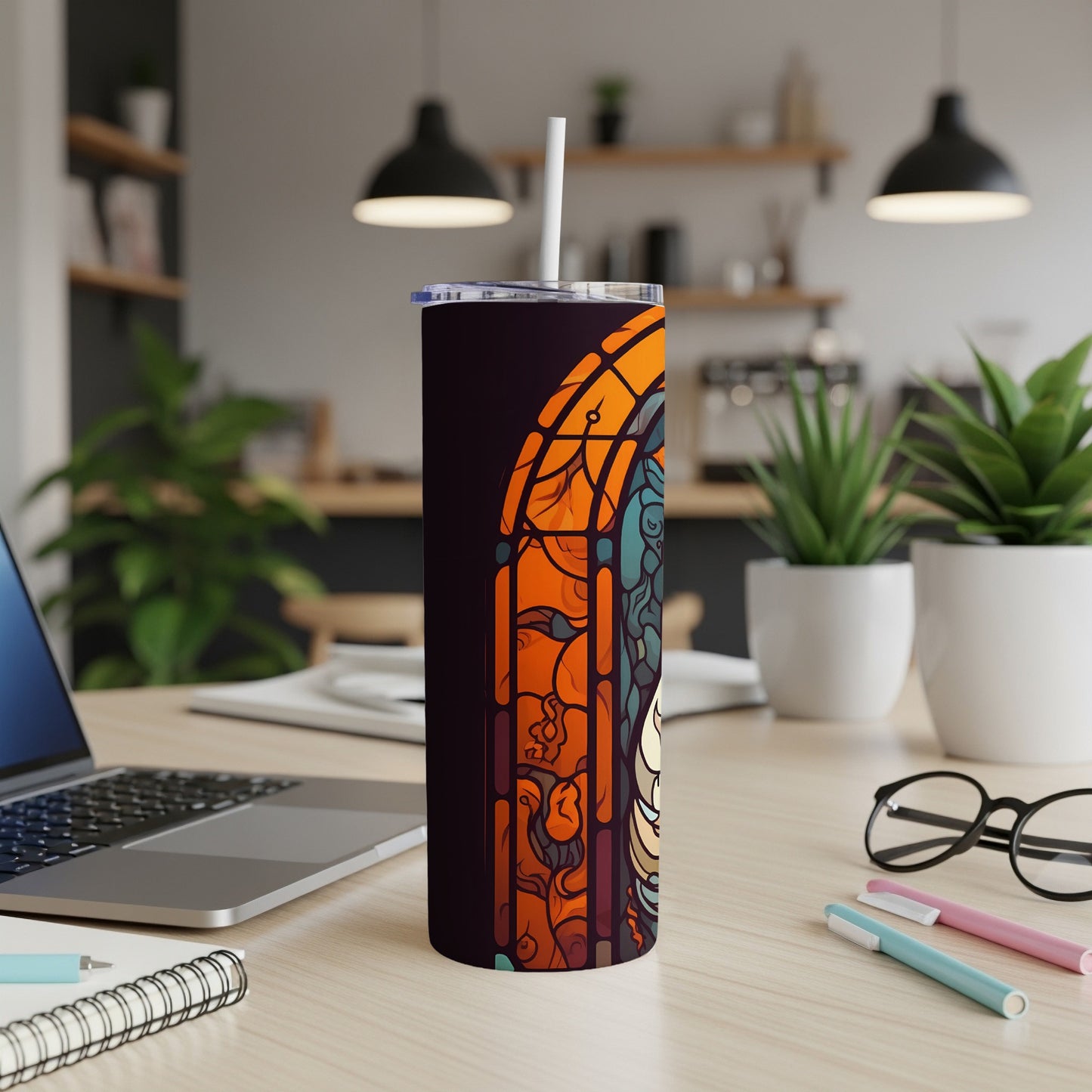 Tumbler with stained glass design of a woman's face.