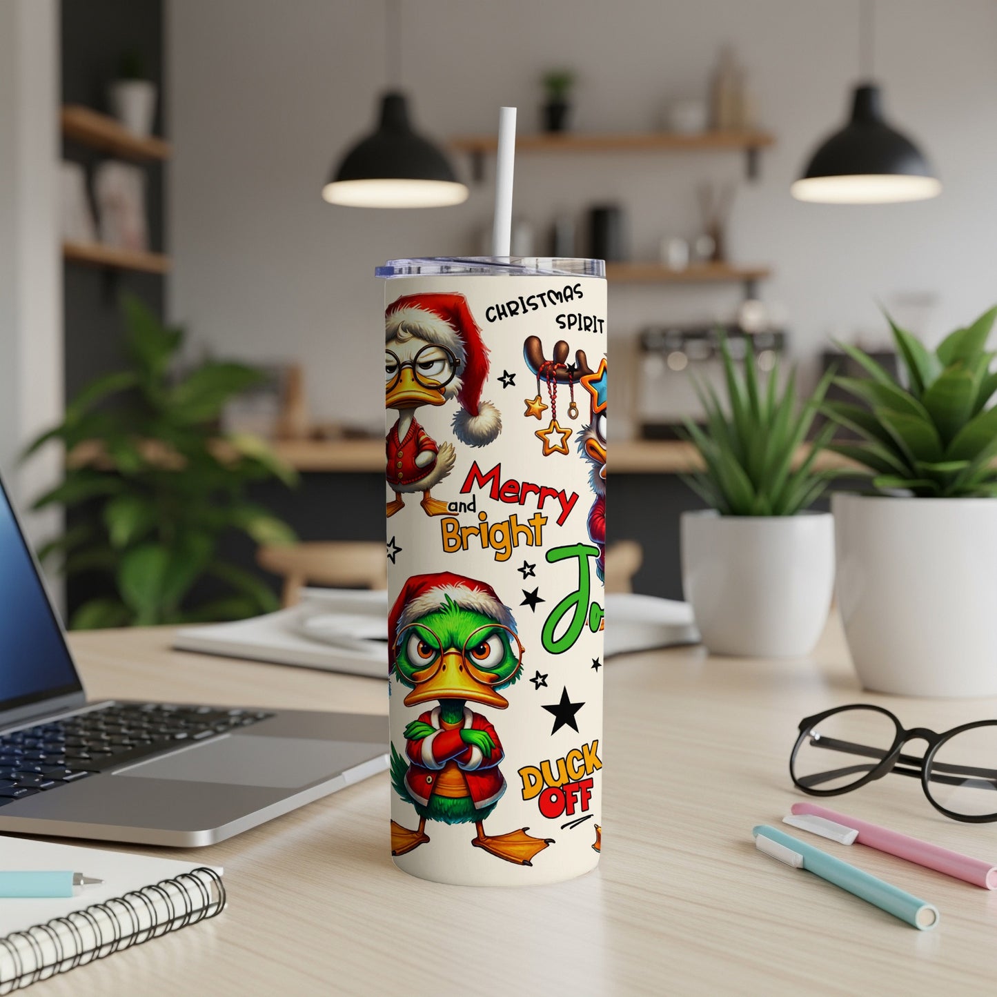 Christmas tumbler with cartoon ducks wearing Santa hats and holiday text.