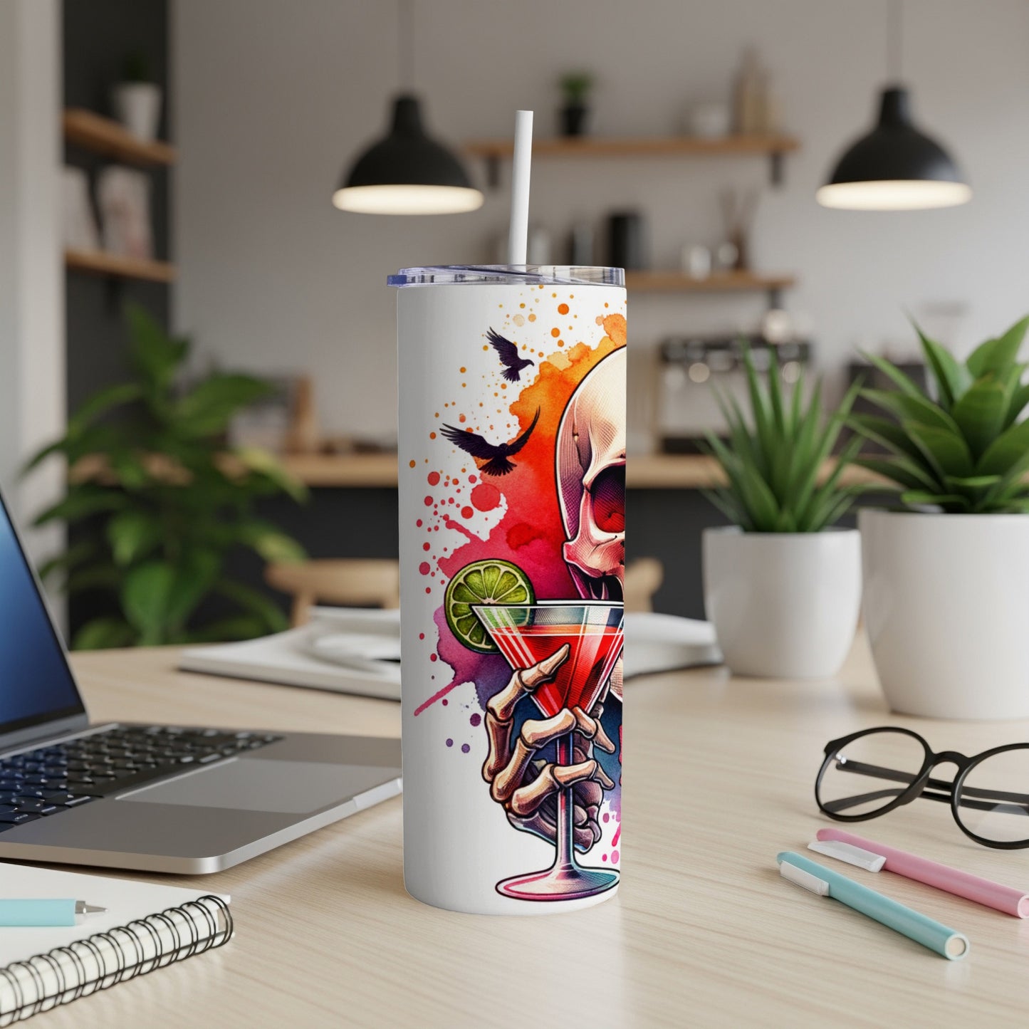 White tumbler with skull and martini glass design, office desk setting.