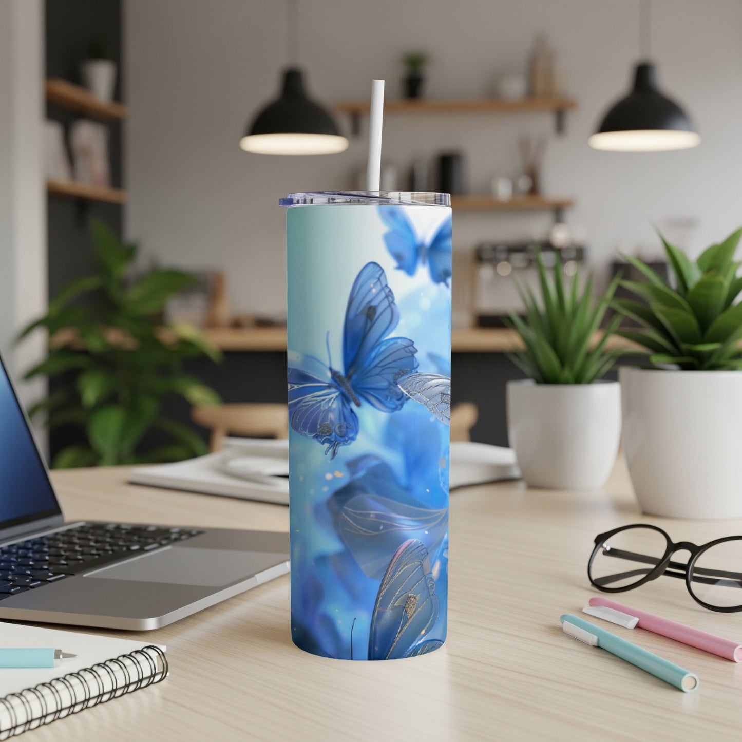 Blue butterflies on a blue gradient tumbler with a white straw.