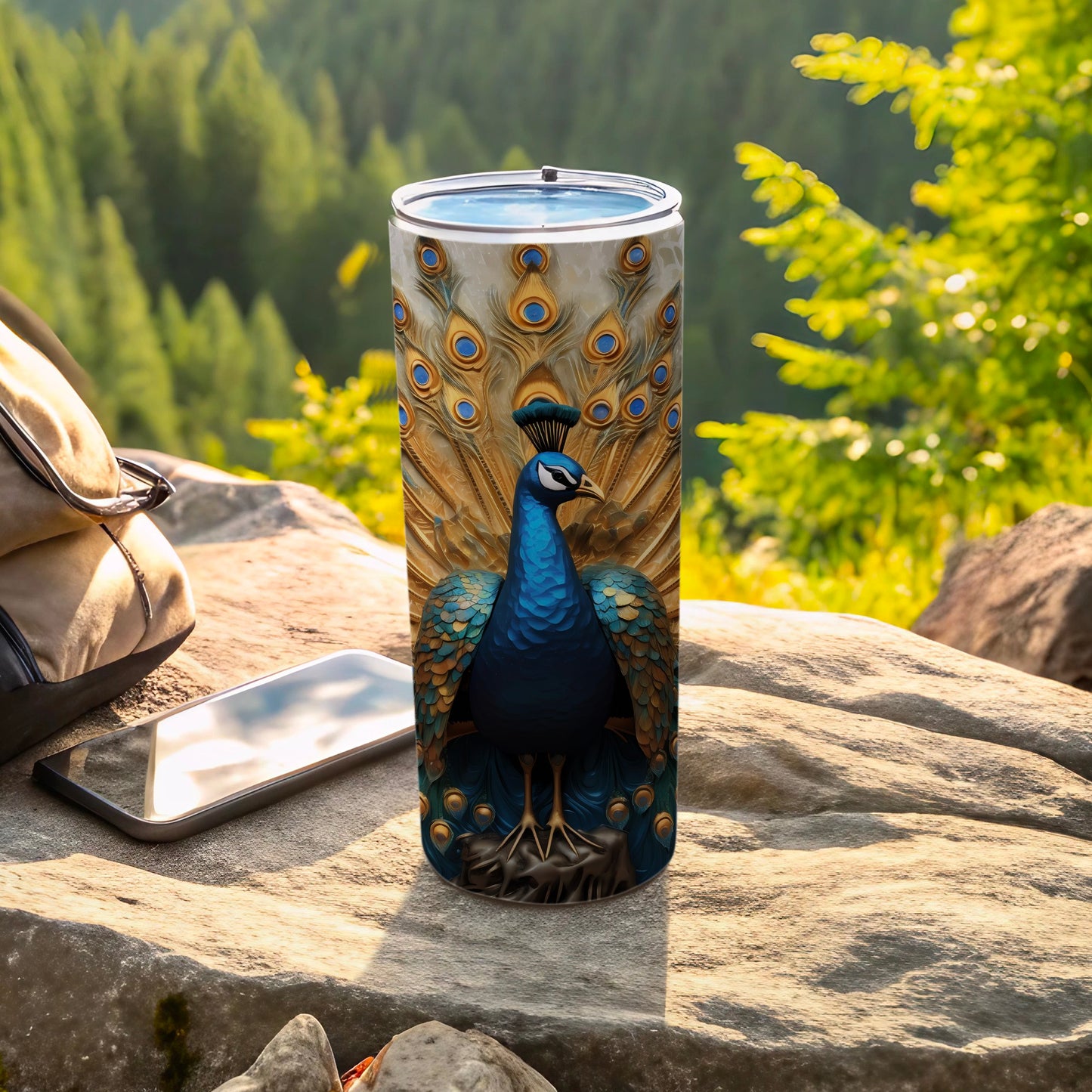 Tumbler featuring a vibrant peacock with detailed feathers, placed on a rock.
