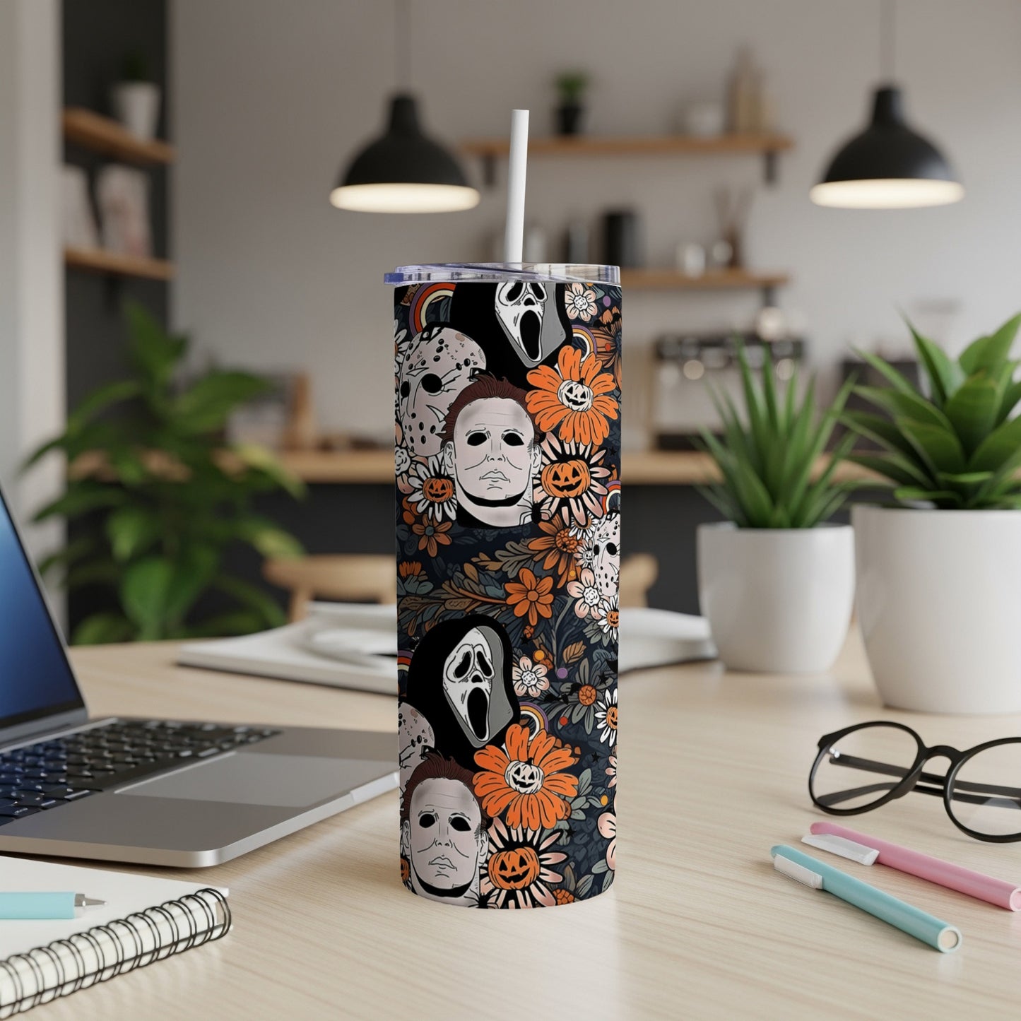 Tumbler with Halloween horror movie masks and floral pattern.