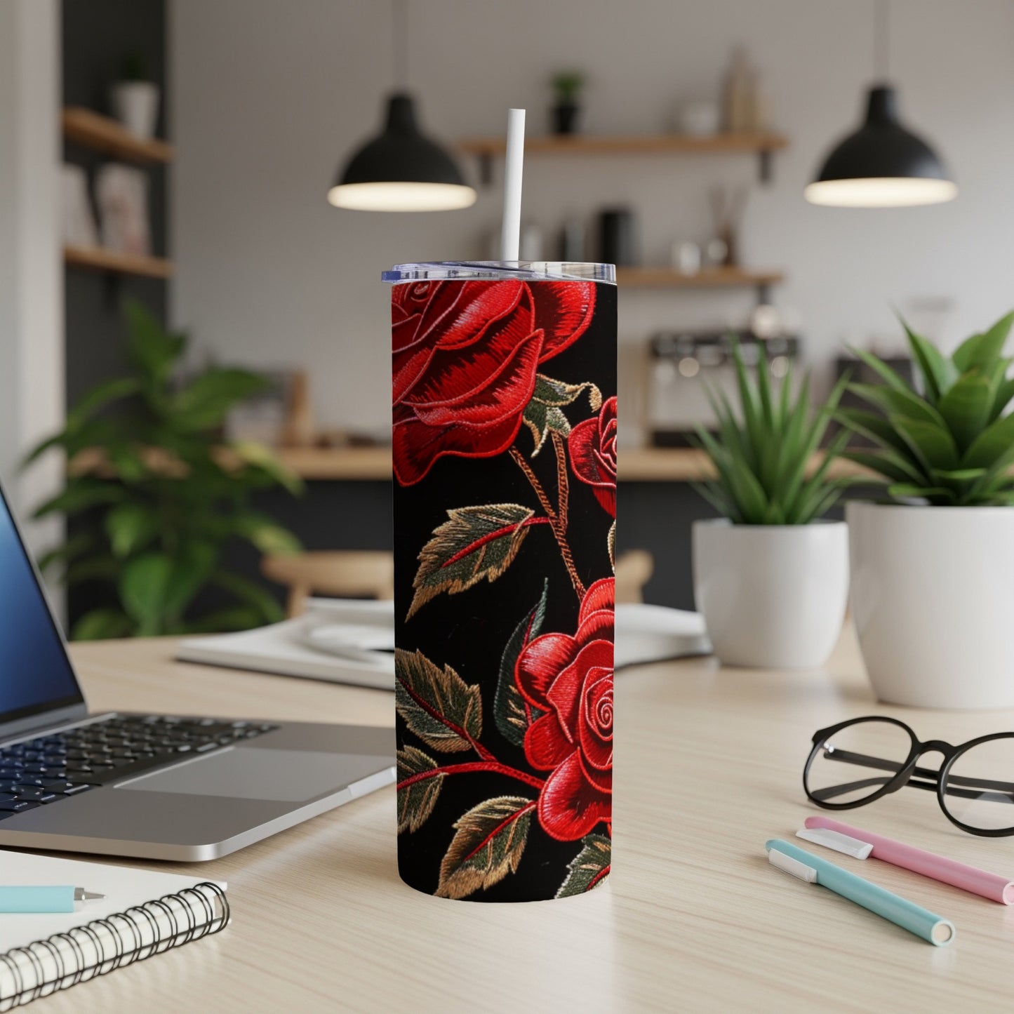 Tall black tumbler with a red rose and vine pattern.