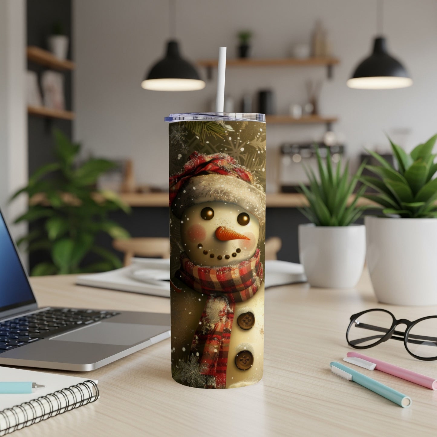 Snowman wearing a scarf and hat with snowflakes on a tumbler.