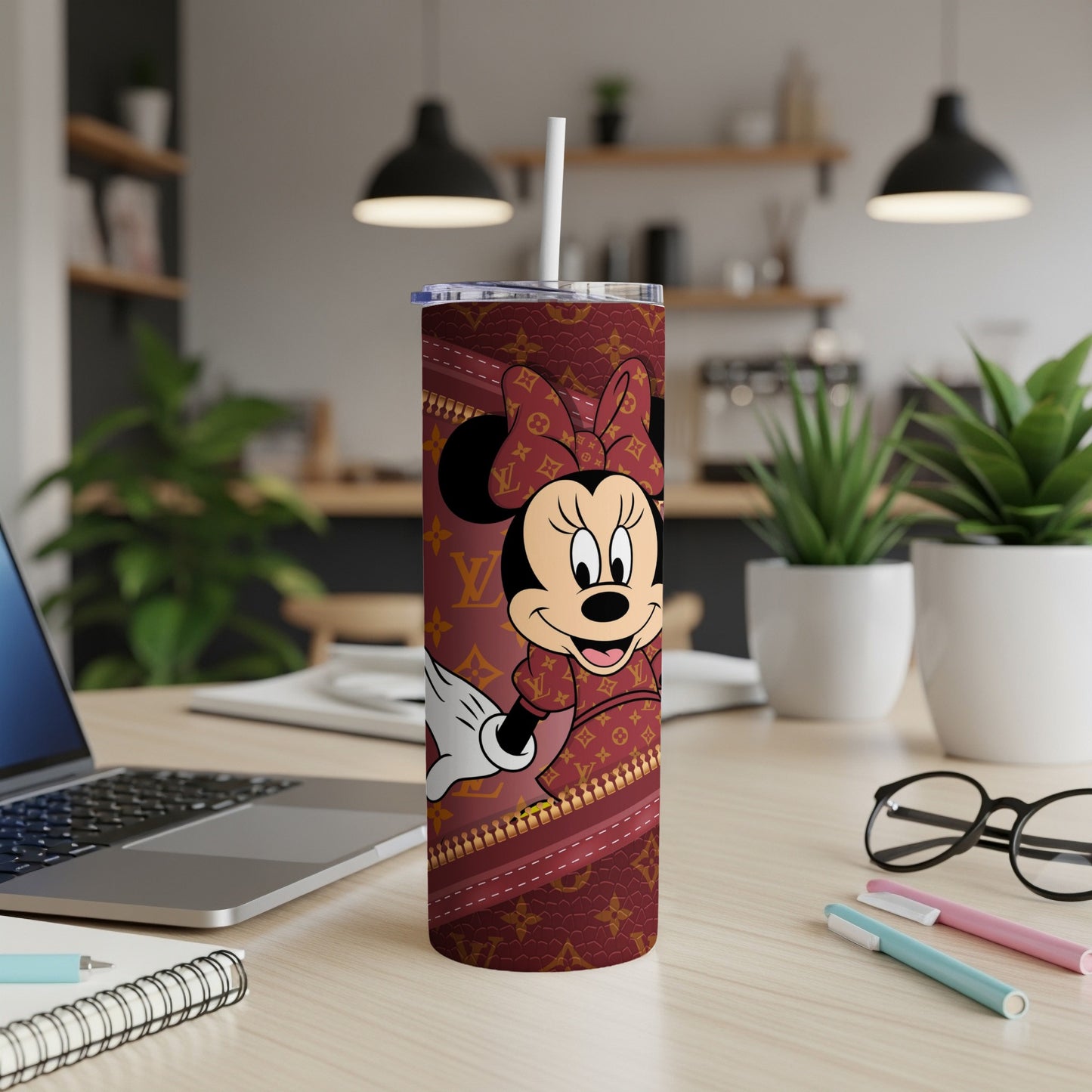 Minnie Mouse on a maroon tumbler with a gold pattern and straw.
