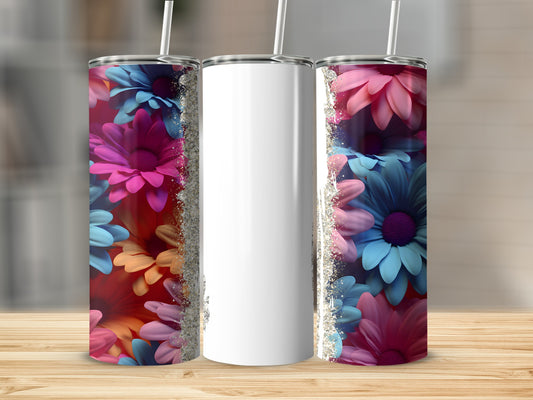 Three tumblers with floral designs and glitter accents on a wooden surface.