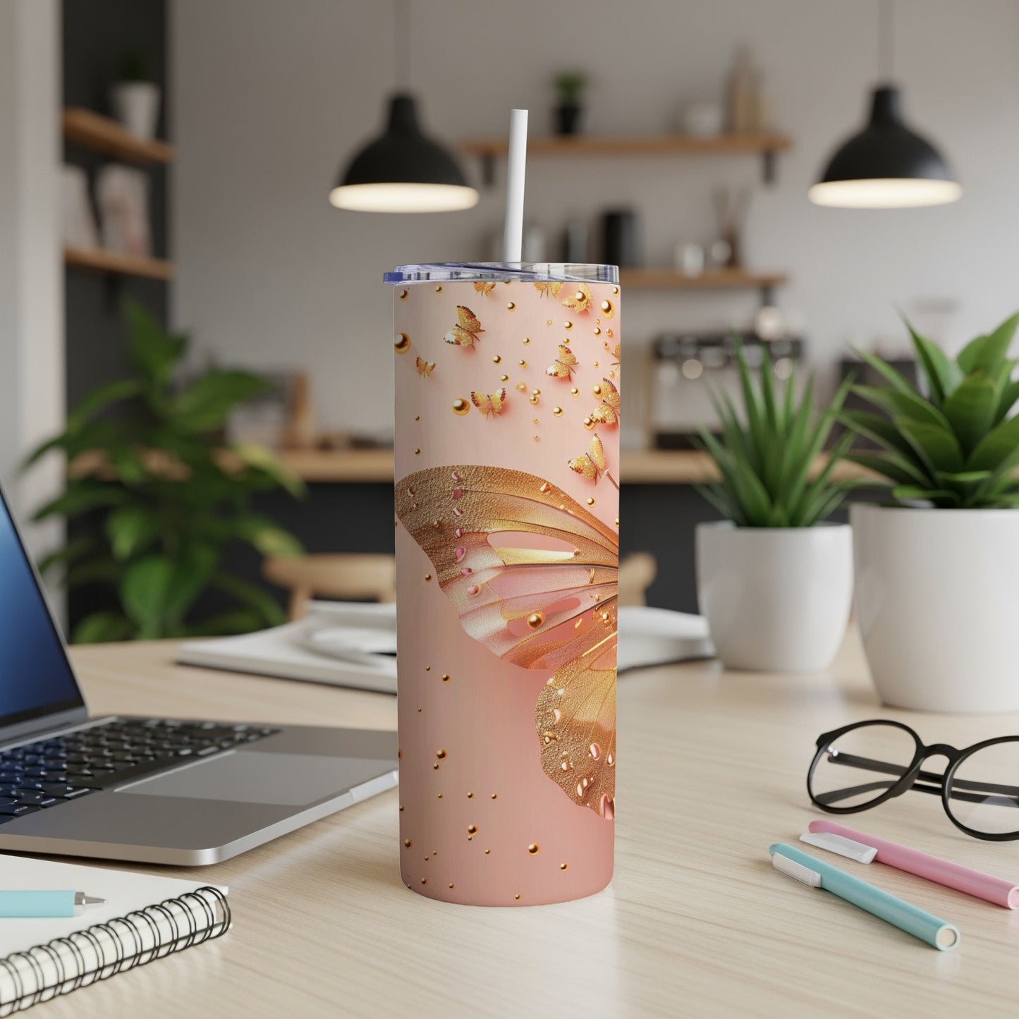 Rose gold tumbler with butterfly wing design and scattered gold dots.