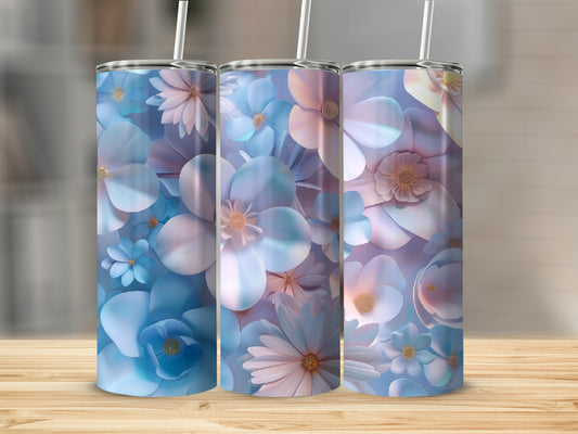 Three blue and pink floral patterned tumblers with straws on a wooden surface.