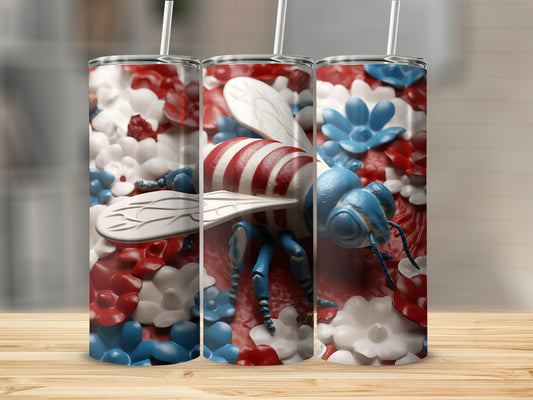 Red, white, and blue bee tumbler with floral accents.