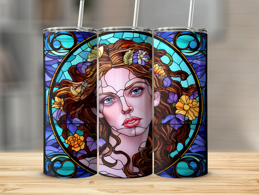 Stained glass tumbler with a woman's face and floral accents.