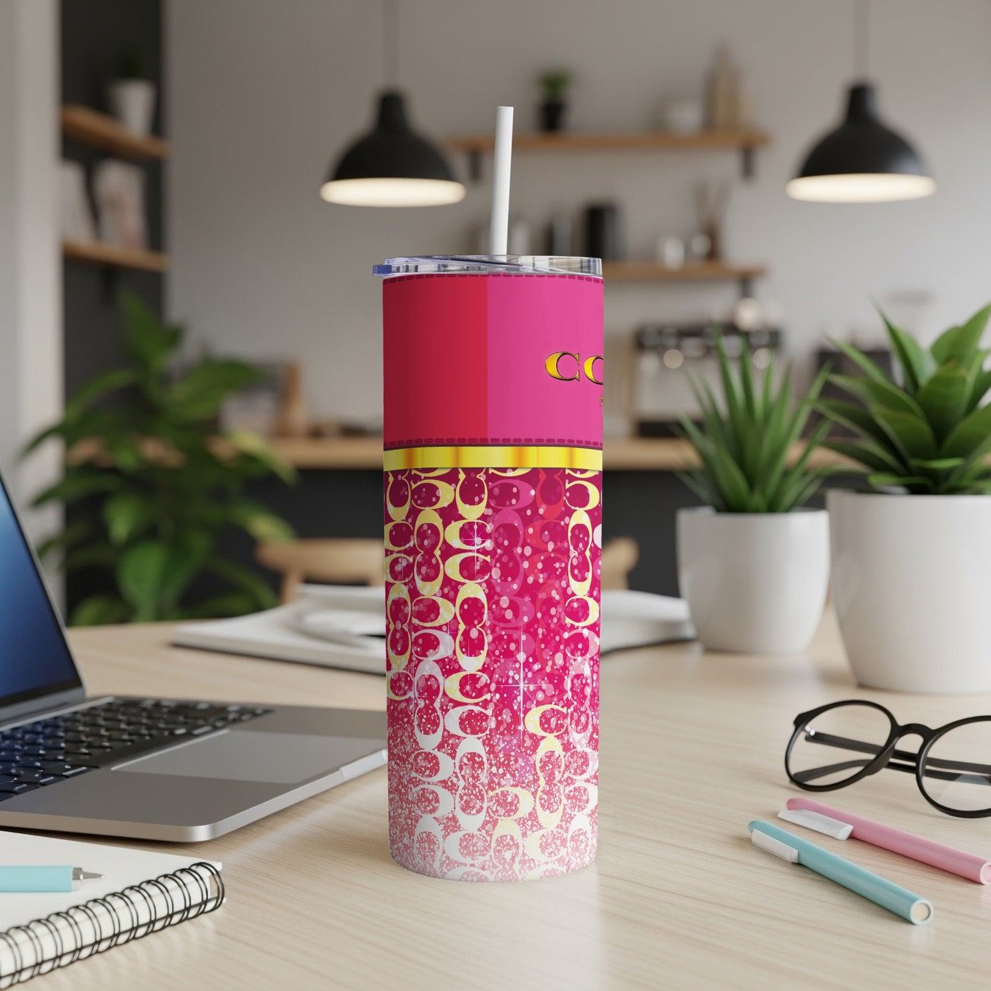 Pink tumbler with white straw and repeated pattern of rounded C shapes.