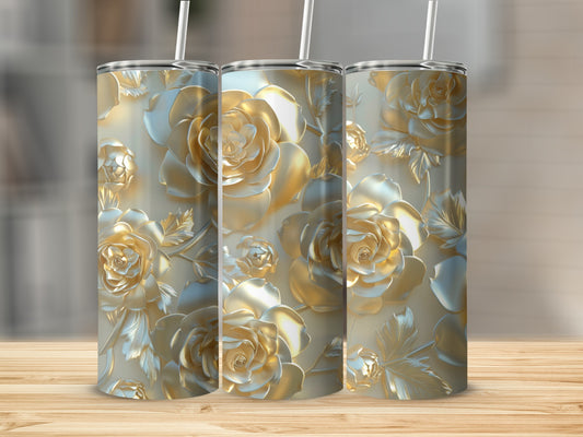 Three golden rose embossed tumblers with straws on a wooden surface.