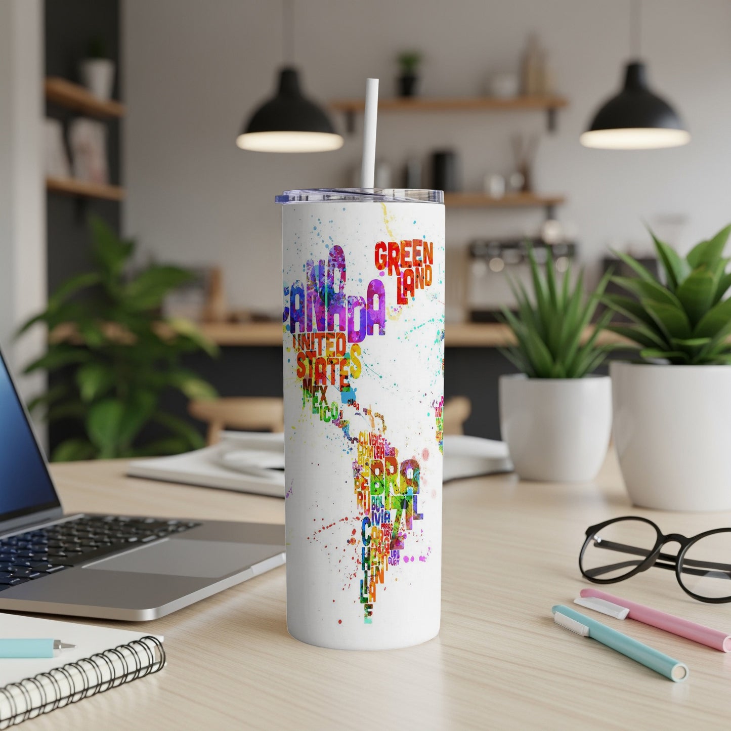 White tumbler with colorful map of the Americas and text including "CANADA" and "GREENLAND".