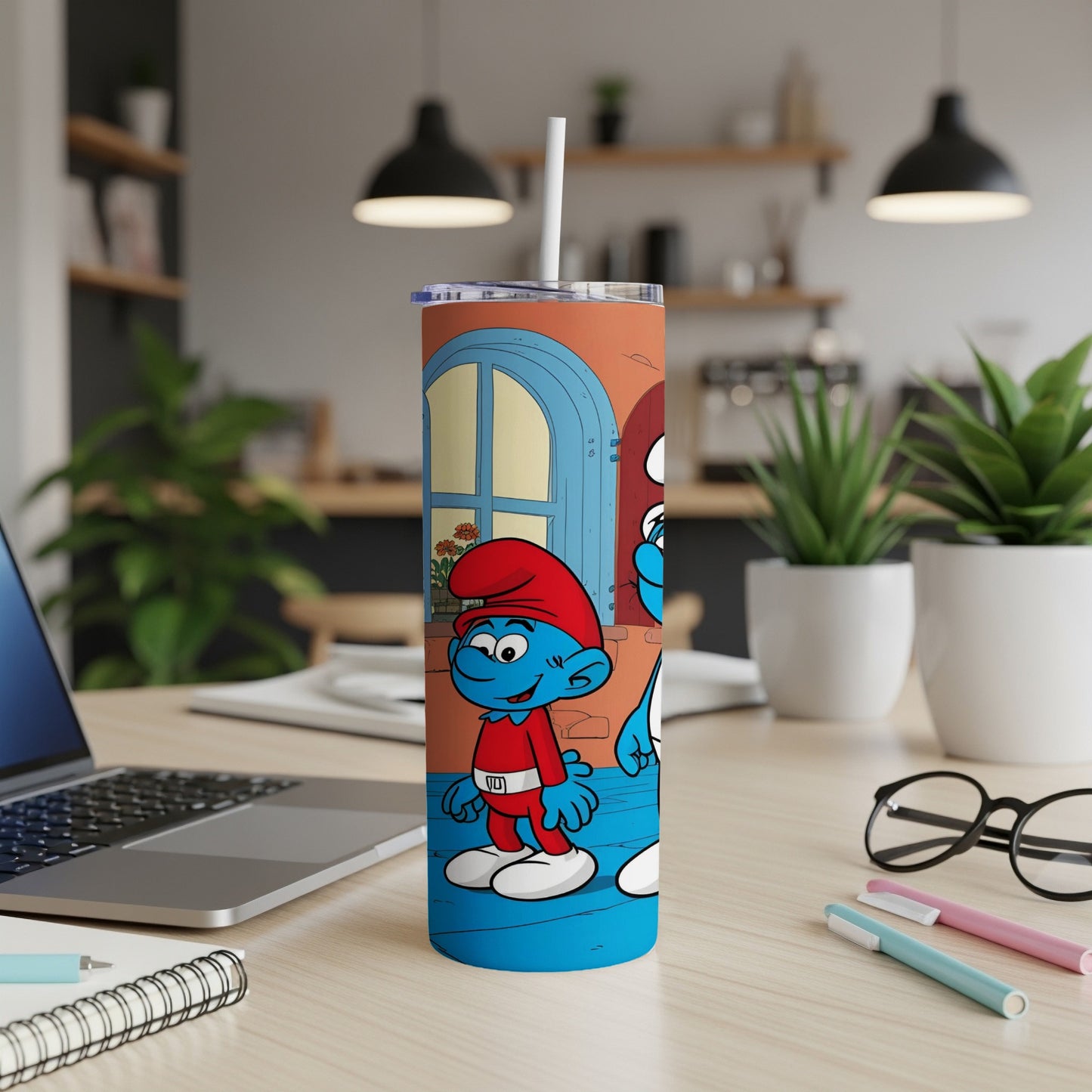 Smurf character in blue overalls and red hat on a tumbler with a kitchen background.