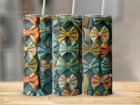 Pattern of colorful bows and open books on three tumblers.