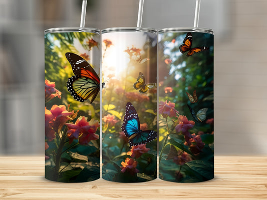 Three tumblers with colorful butterflies and flowers against a sunlit background.