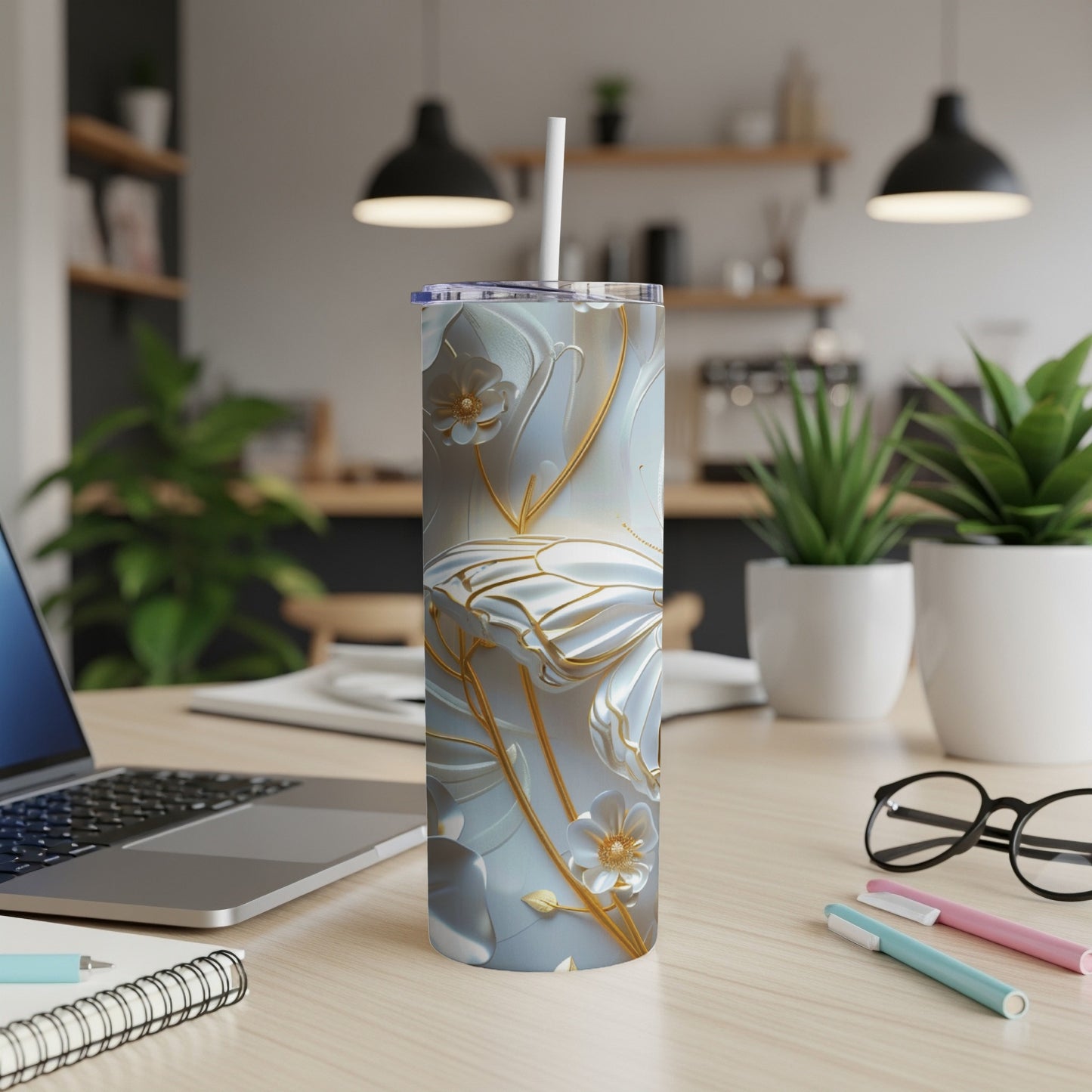 White tumbler with gold butterfly and floral design on desk.