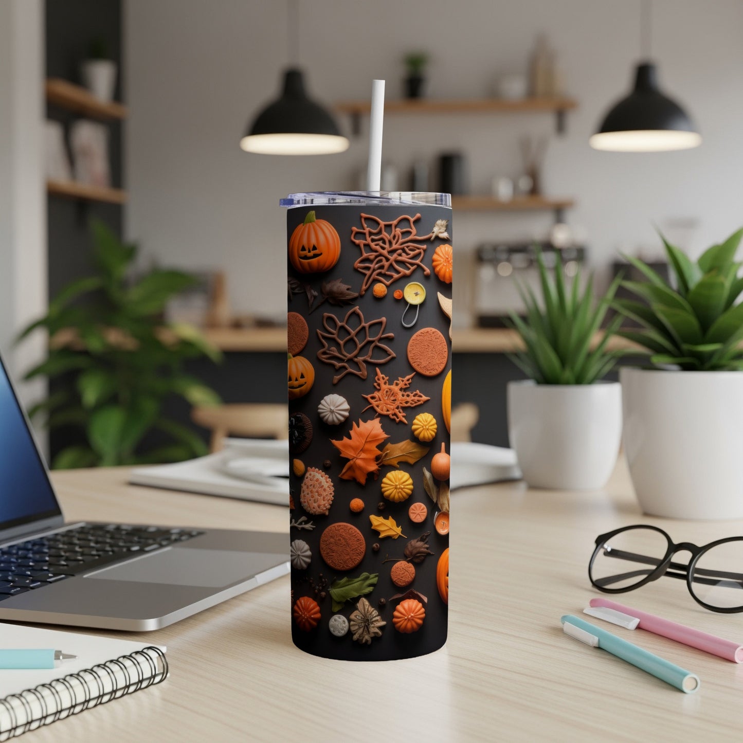 Black tumbler with Halloween and fall leaf designs, featuring pumpkins and foliage.